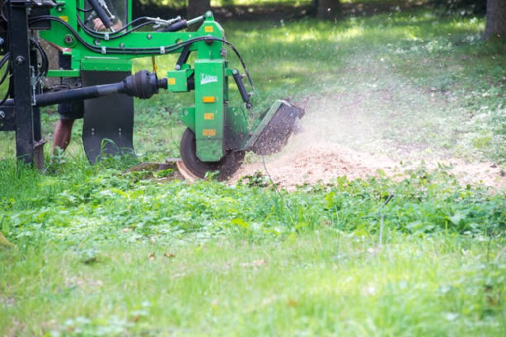 Professional stump grinding machine removing a tree stump below ground level during stump grinding and removal service in Eureka, MO.