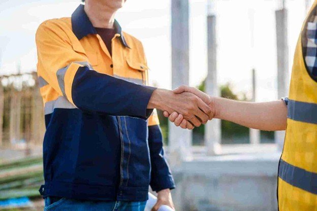 Riverbend Tree Service representative shaking hands with a satisfied homeowner after completing professional emergency tree service in Eureka, MO.